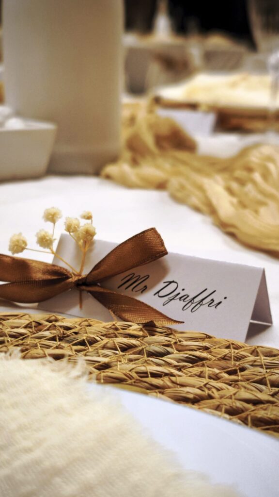 marque place blanc avec écriture manuscrite et ruban marron et fleurs séchées